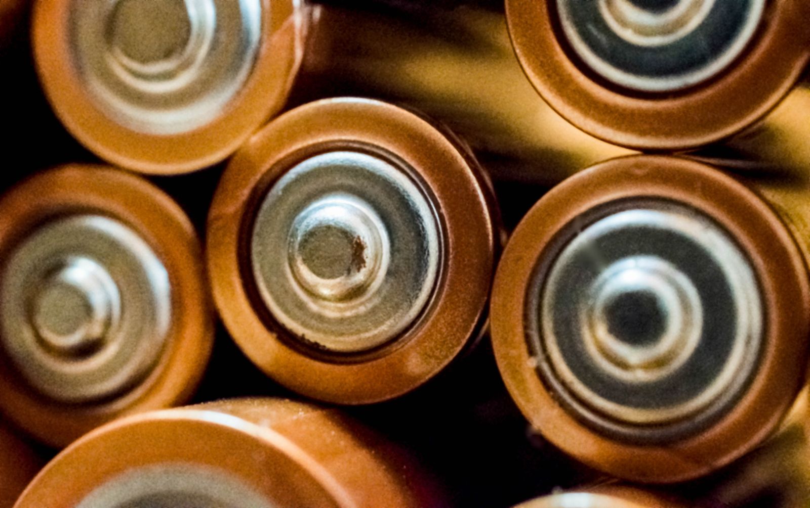Close-up of the positive terminals of stacked cylindrical battery cells
