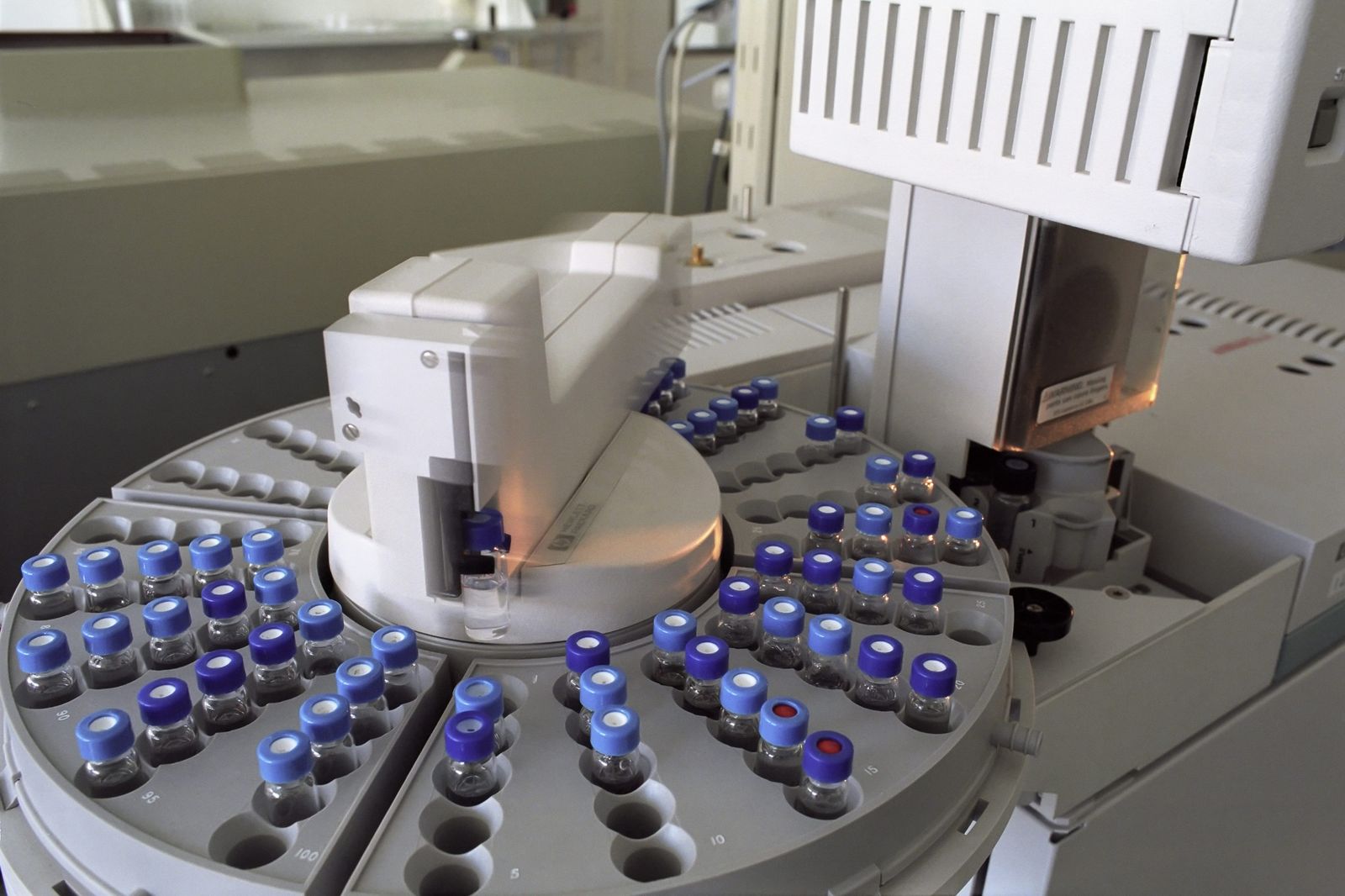 Capped sample vials loaded on the carousel of a chromatography autosampler
