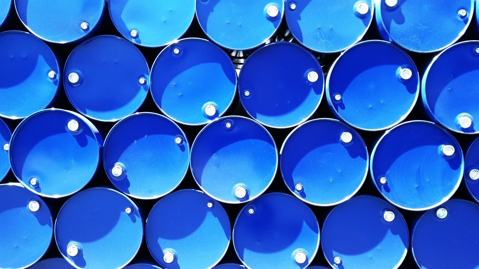 Sealed industrial drums stacked for storage and dispatch
