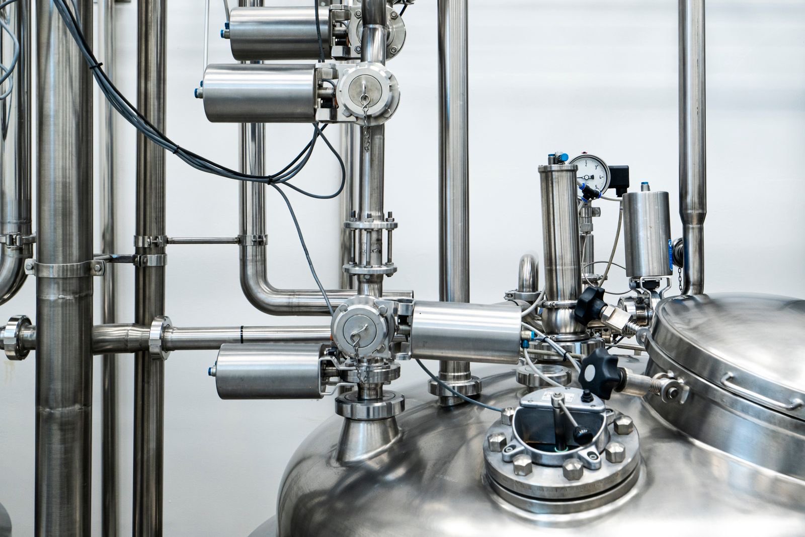 Stainless steel reactor vessel with process piping, valves and a pressure gauge