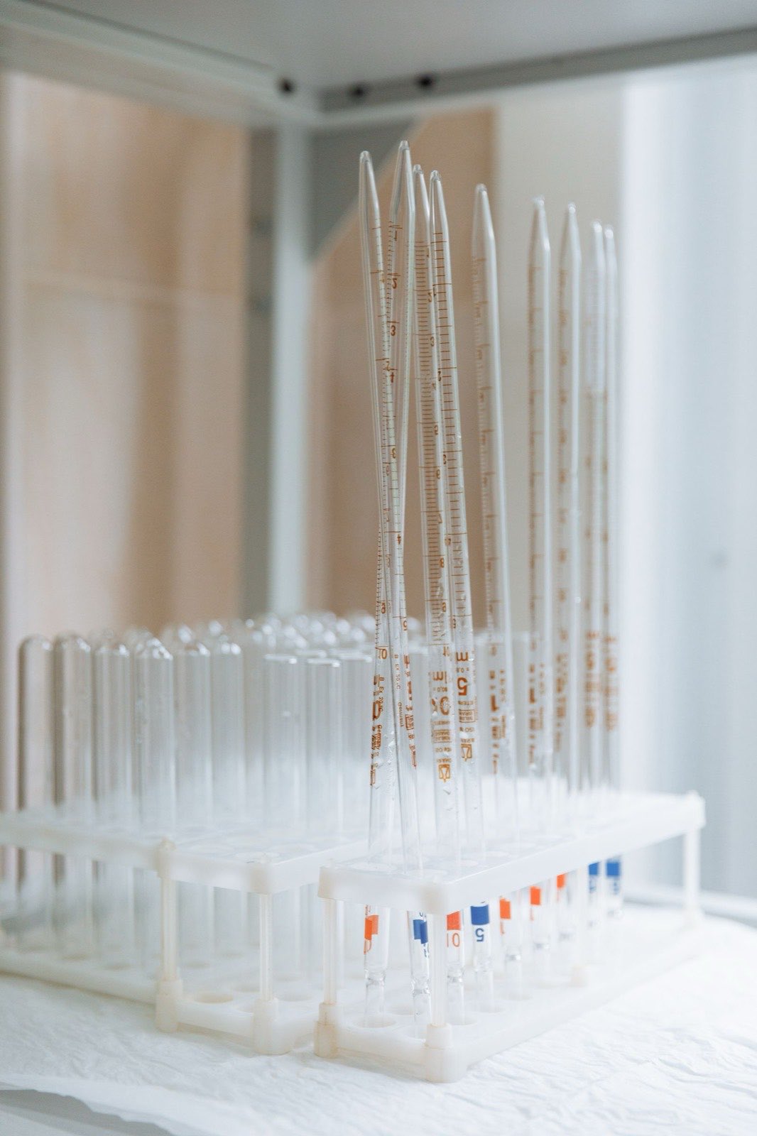 Graduated pipettes and test tubes racked for analytical work